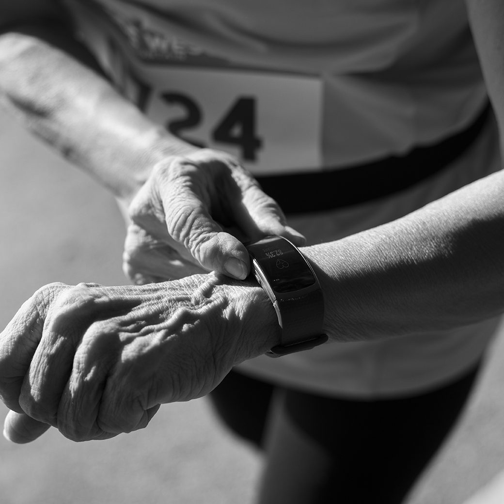 senior-runner-using-fitness-tracker